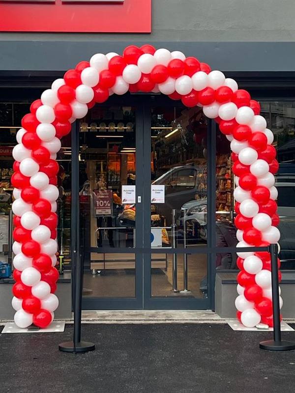 Red and white spiral entrance balloon arch Pune